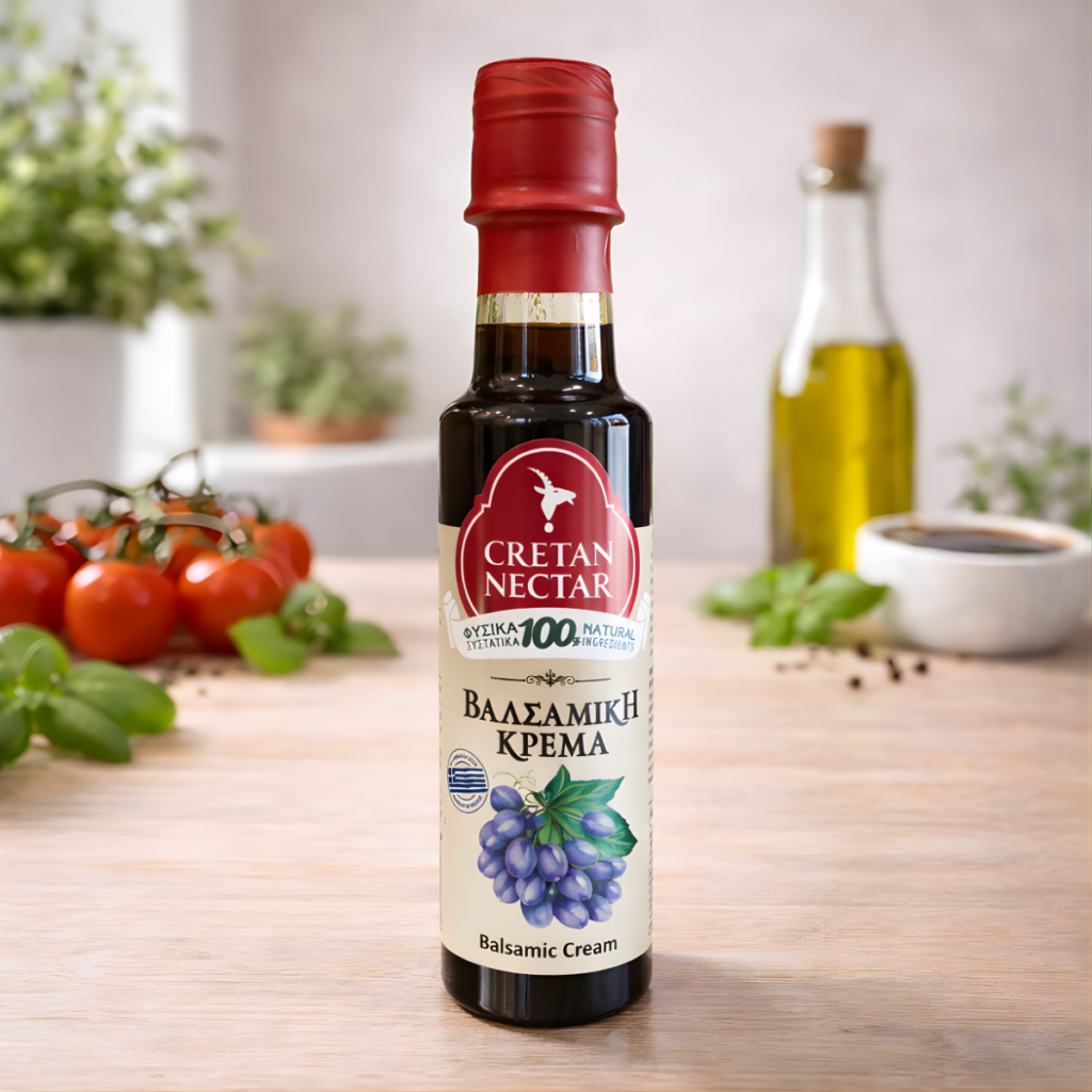 Bottle of balsamic cream, next to fresh tomatoes.