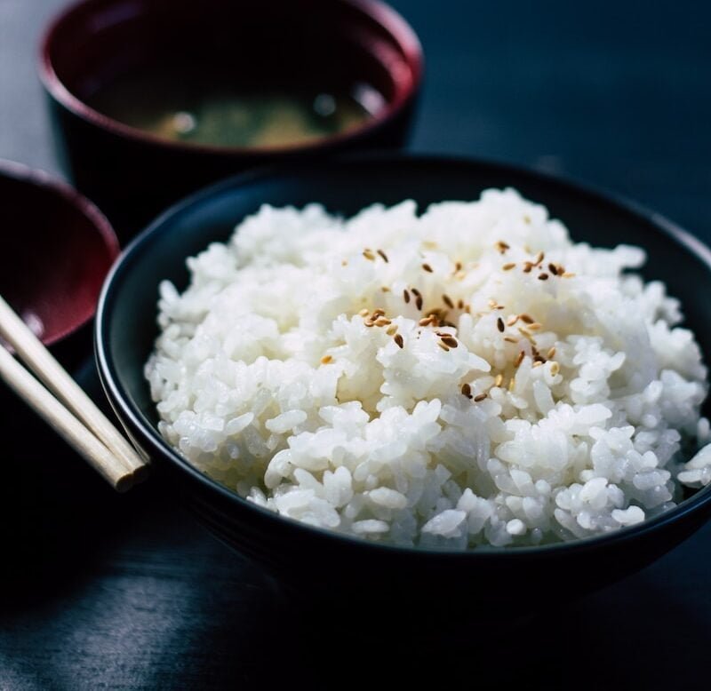 rice with sesame in black bowl