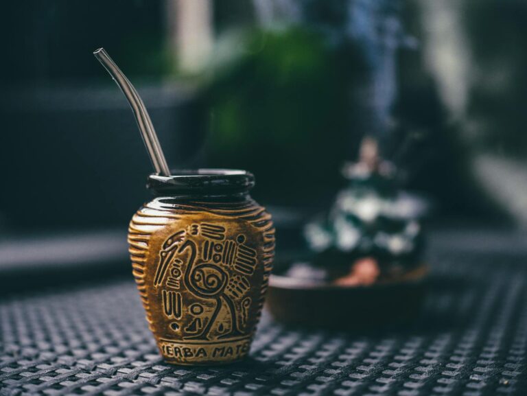 Close-up of a decorated yerba mate cup with straw, embodying traditional design and cultural essence.